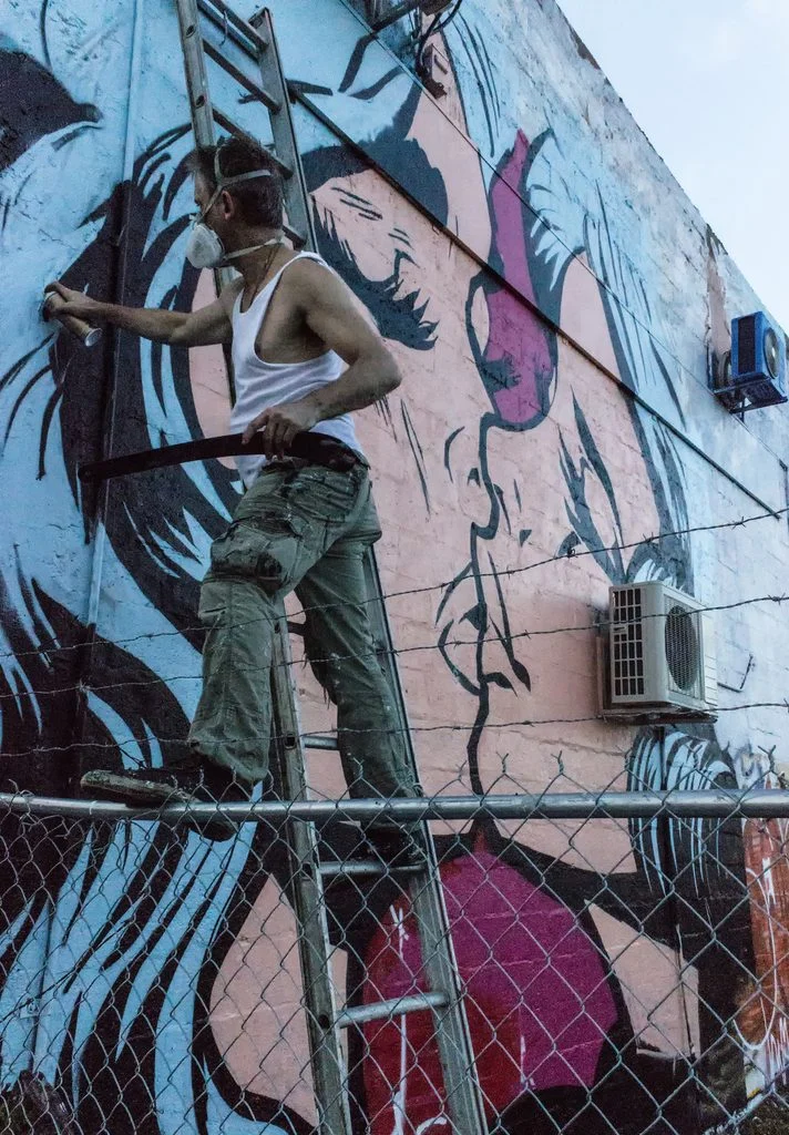 Stephen Bliss working on mural “The Kissing”. Ph: Sean Ryan Stephen Bliss working on mural “The Kissing”. Ph: Sean Ryan
